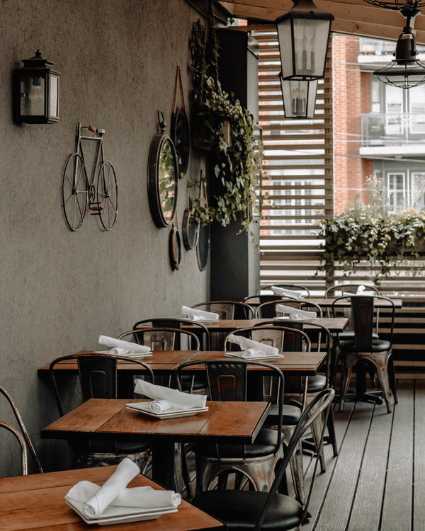 shaded restaurant seating area with wooden plank flooring and industrial lighting showing interior design