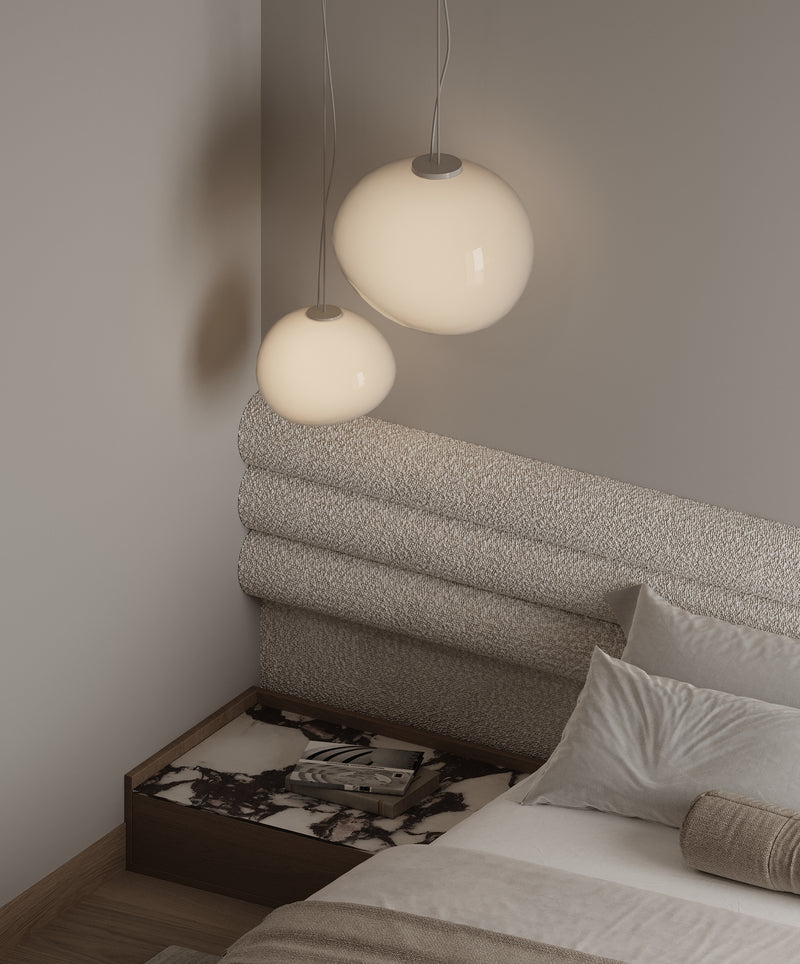Bedroom with textured headboard and pendant lights