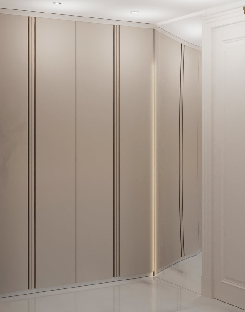 Beige wardrobe with sliding doors in a room with white walls and ceiling.