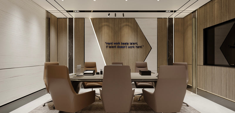 Modern conference room with beige chairs, a table, and a motivational quote on the wall.