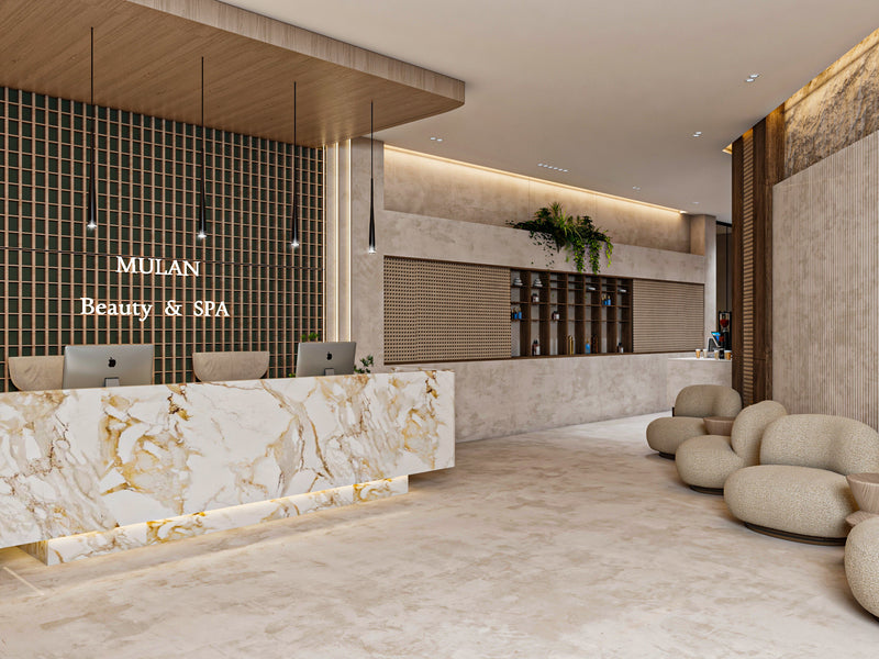 Interior of a beauty and spa with marble reception desk and 'Mulan Beauty & Spa' sign.