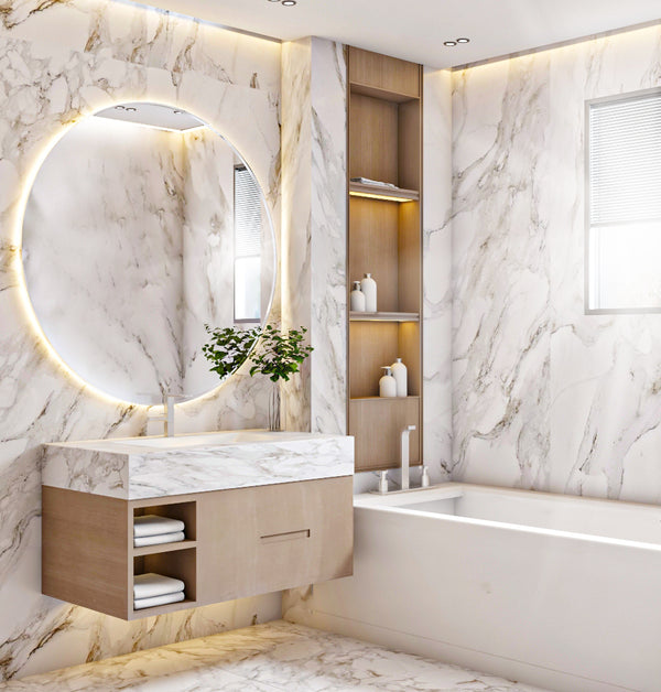 Luxury bathroom with marble walls, a round mirror, and a bathtub.