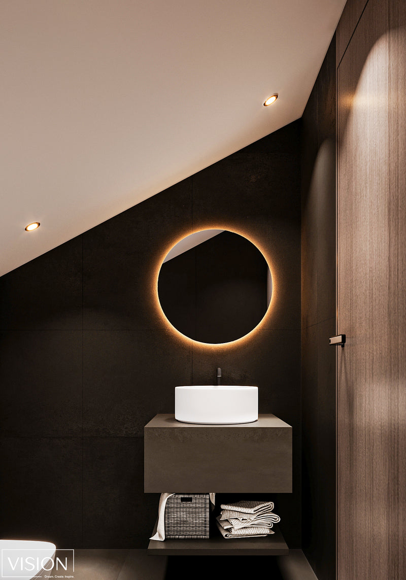 Modern bathroom with a round mirror with lighting and a sink.