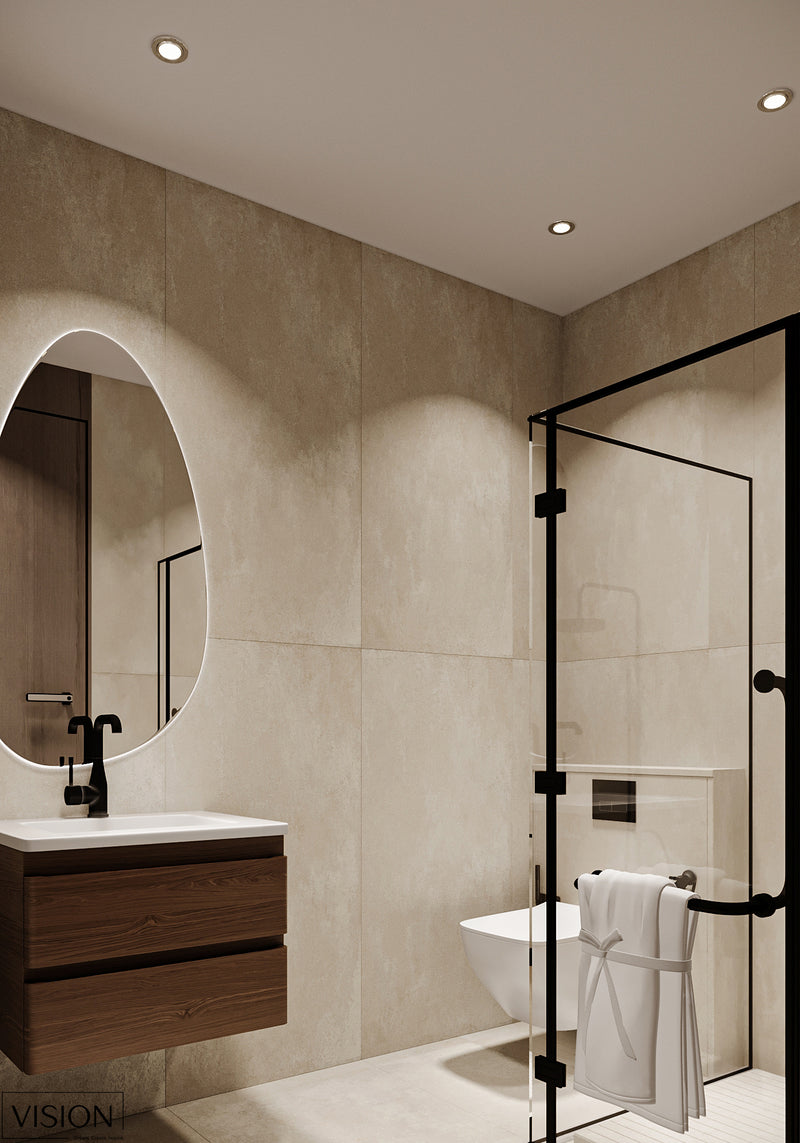 Modern bathroom with beige tiles, a round mirror, and a shower area.