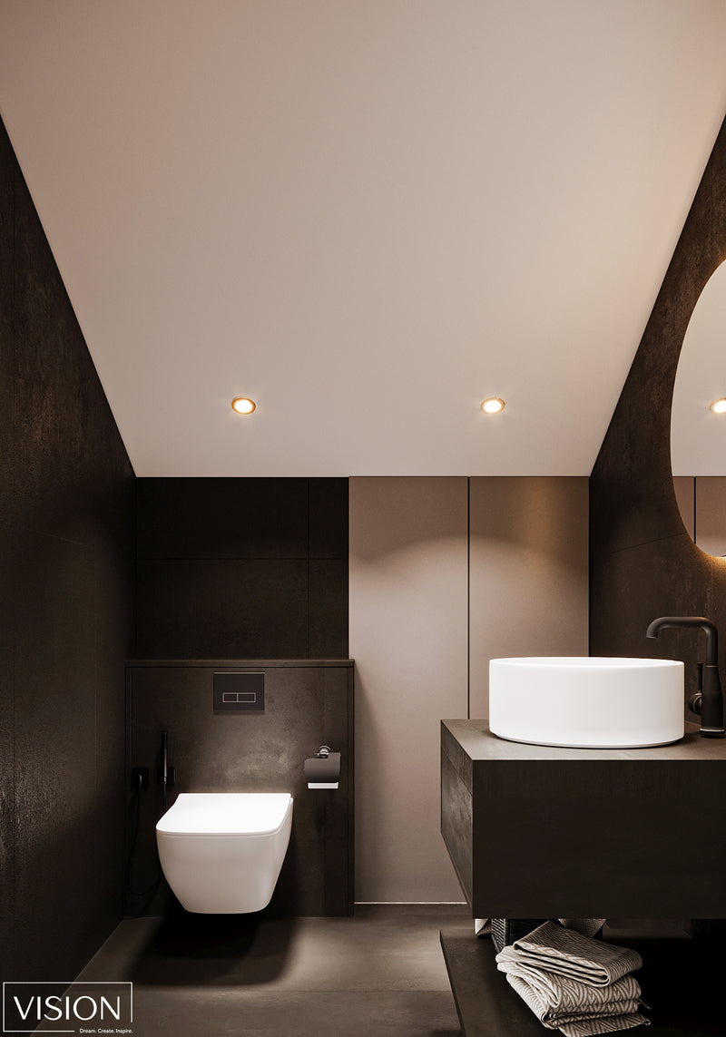 Modern bathroom with dark walls, white fixtures, and a mirror.