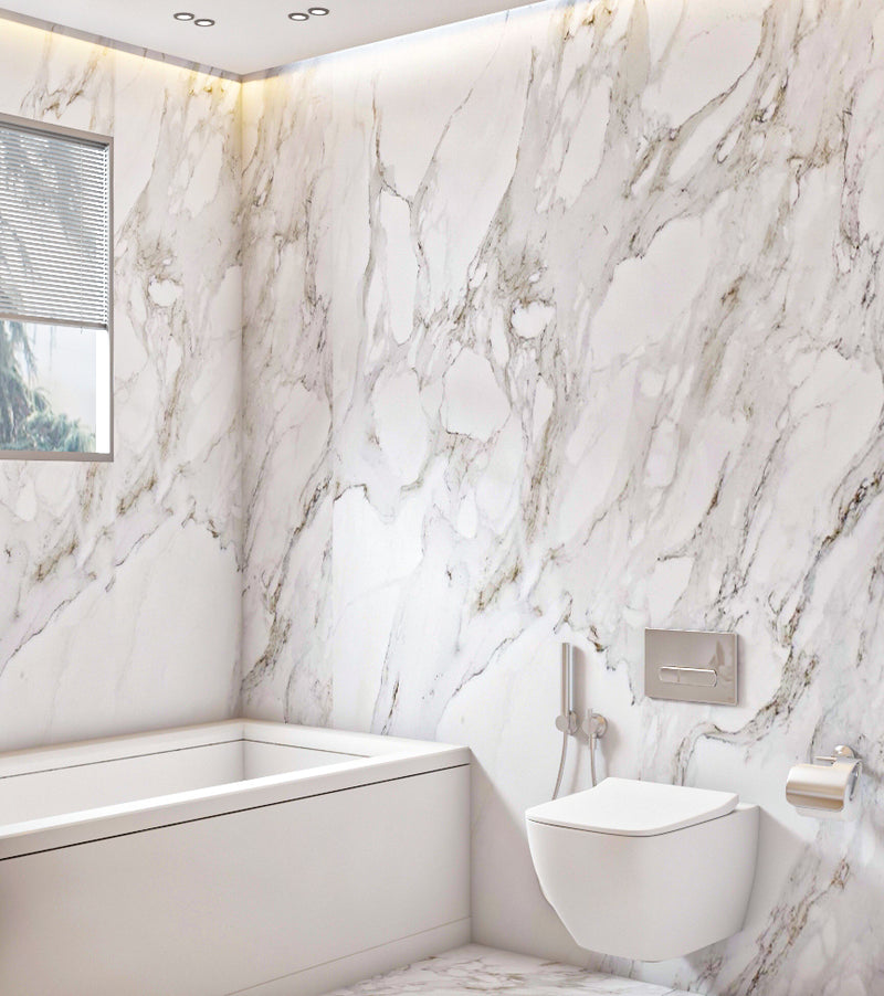 Modern bathroom with marble walls and a white bathtub.