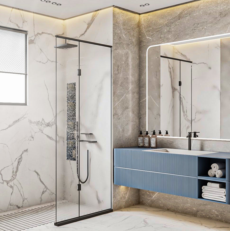 Modern bathroom with marble walls, glass shower enclosure, and blue vanity.