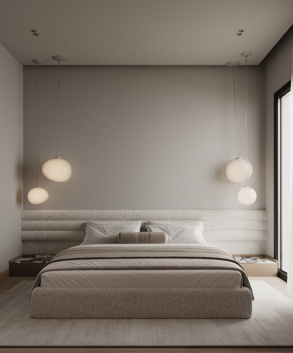 Modern bedroom with a bed, pillows, and wall-mounted lights.