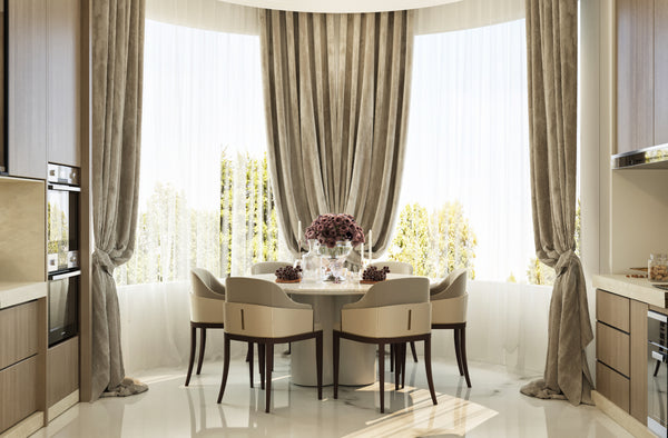 Modern kitchen with a dining area featuring a round table and chairs.