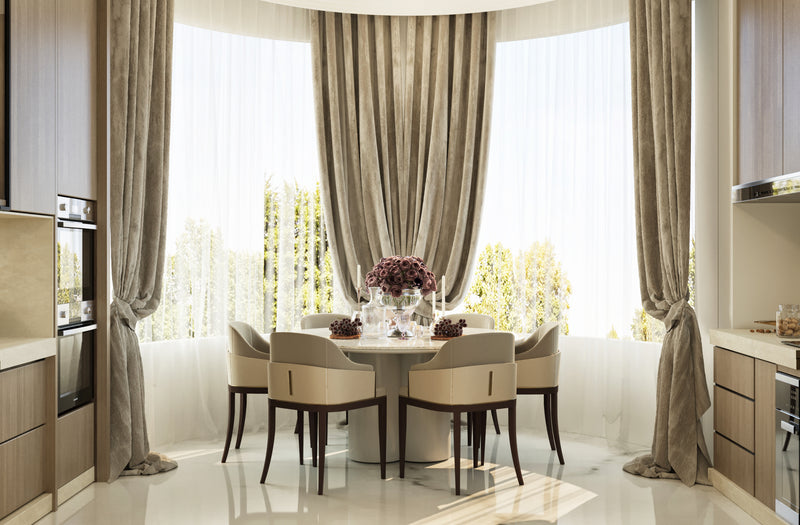 Modern kitchen with a dining area featuring a round table and chairs.
