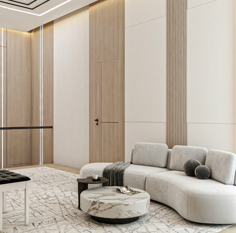 Modern living room with a gray sectional sofa, marble coffee table, and wooden accent wall.
