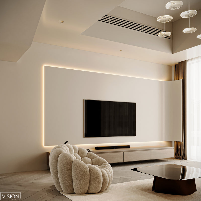 Modern living room with a large TV mounted on the wall, a textured armchair, and a coffee table.