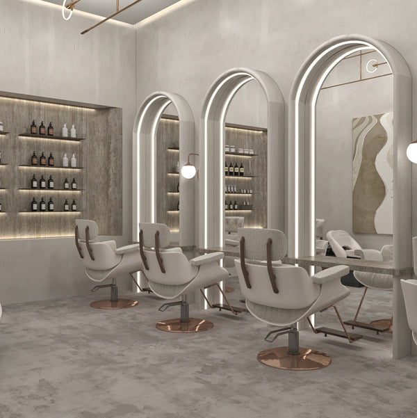 Modern salon interior with white chairs and large mirrors.