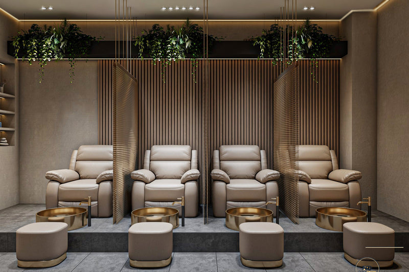 Modern spa room with beige recliner chairs and gold side tables.