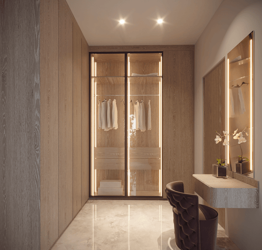 Modern walk-in closet with illuminated mirror and clothing display.