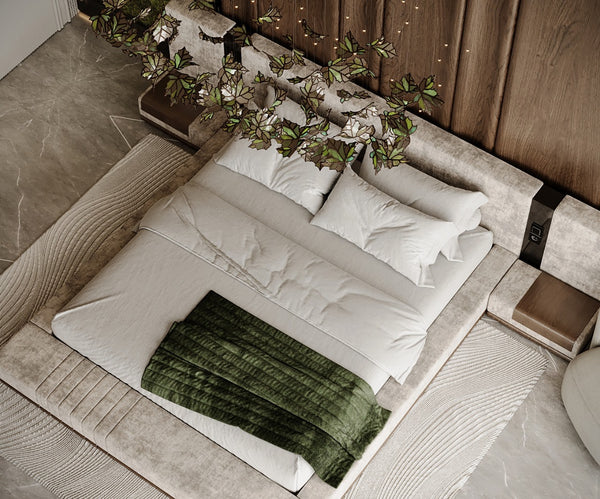 Neatly made bed with white bedding and green blanket in a master bedroom setting.