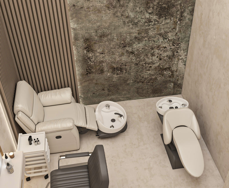 Salon chair and styling station with mirrors against a textured wall.