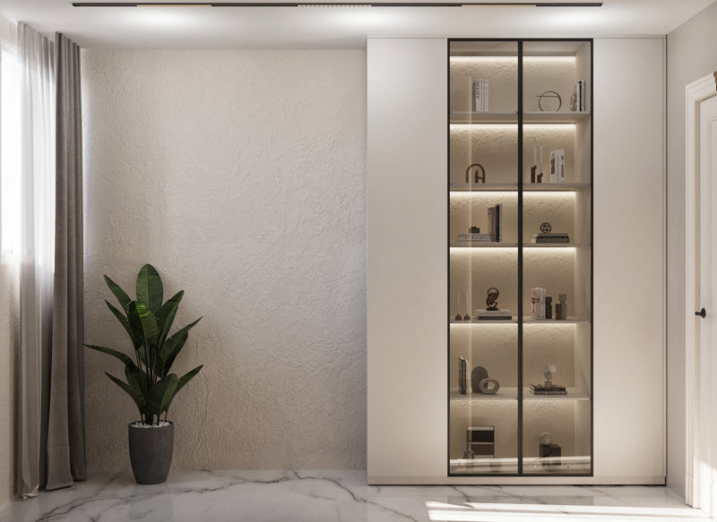 Modern interior with a tall glass cabinet against a neutral wall, featuring decorative items.