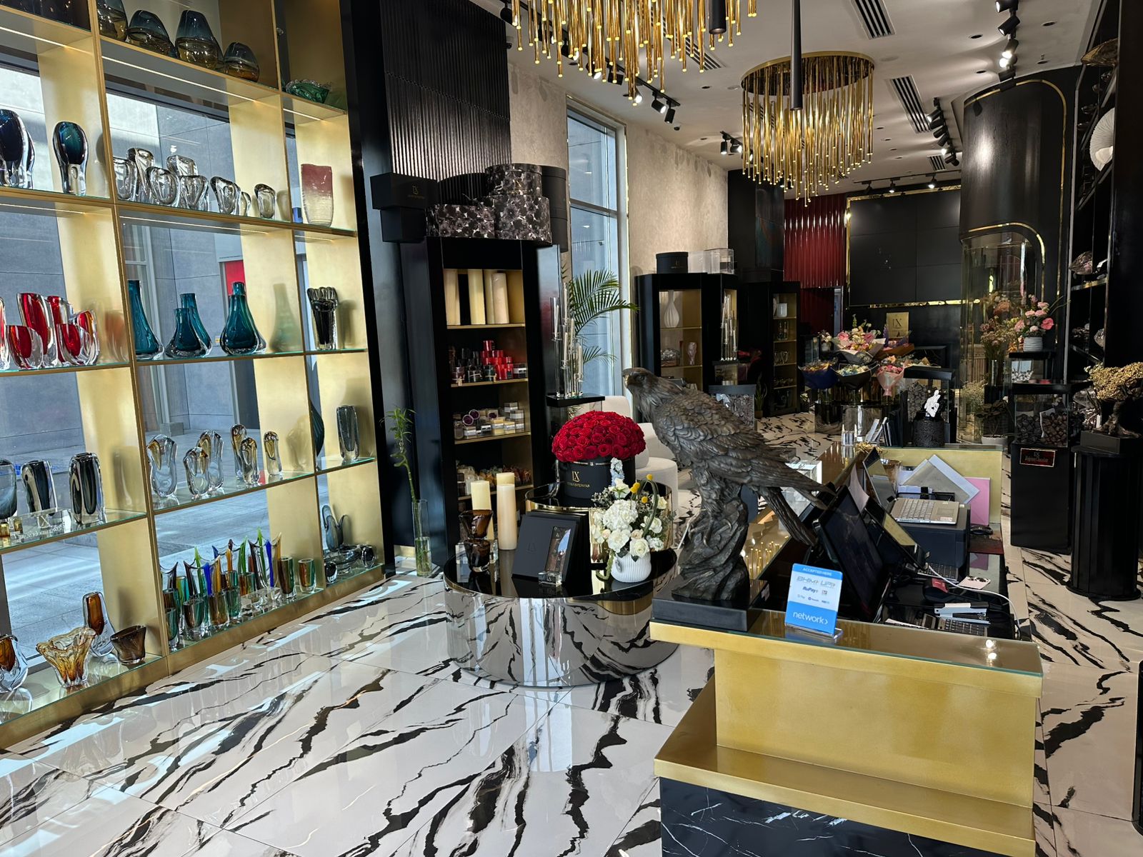 flower shop interior design with decorative items, a reception desk, and chandeliers.