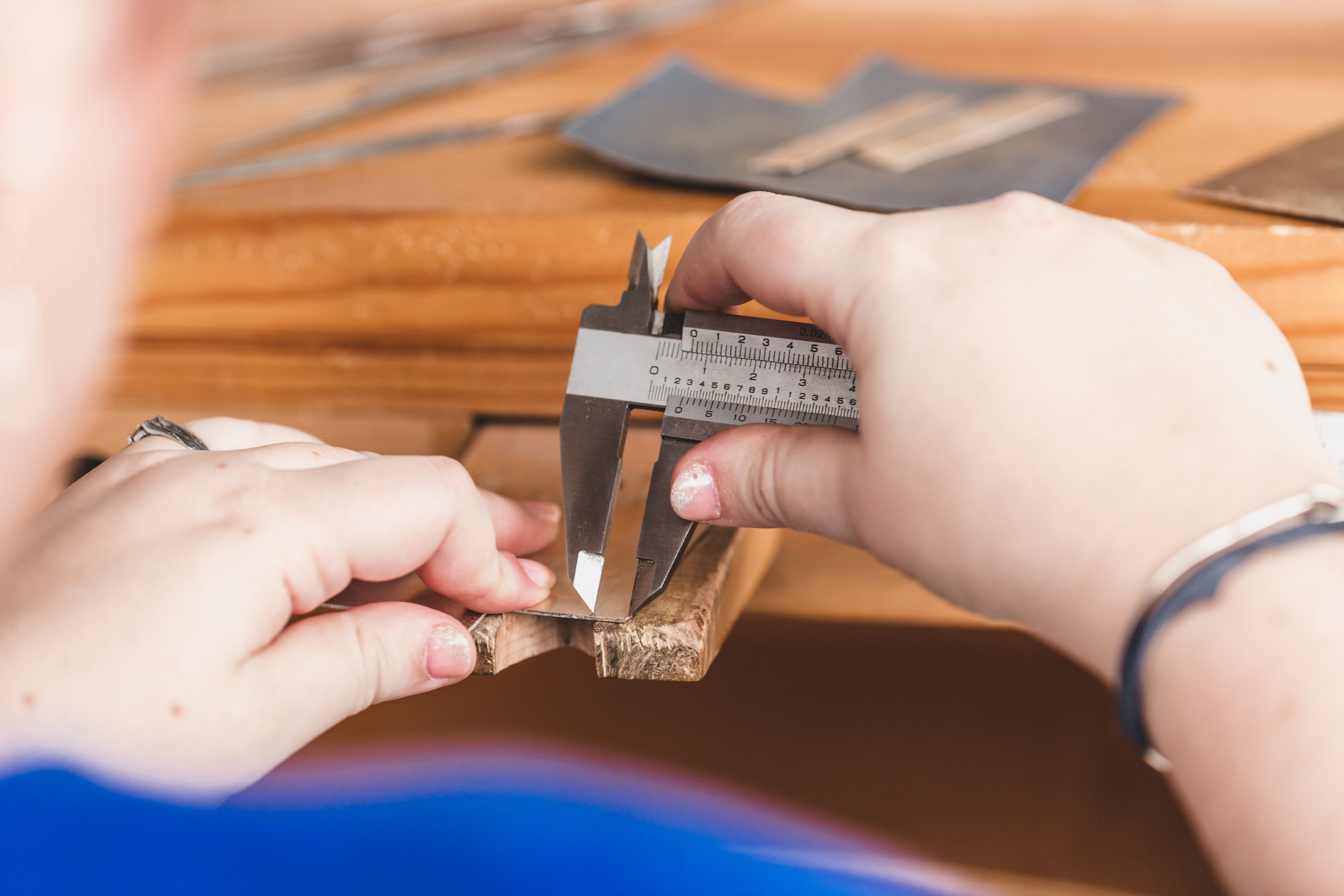 Precision measurement being taken with a caliper for a custom furniture or interior design component